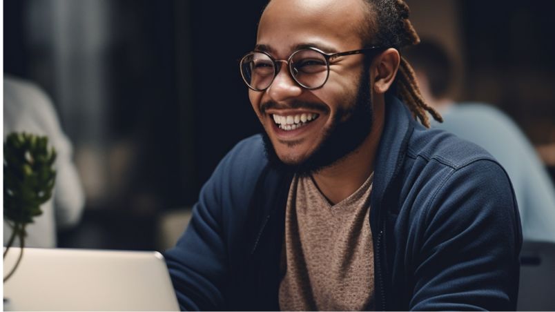Man smiling and using the notebook
